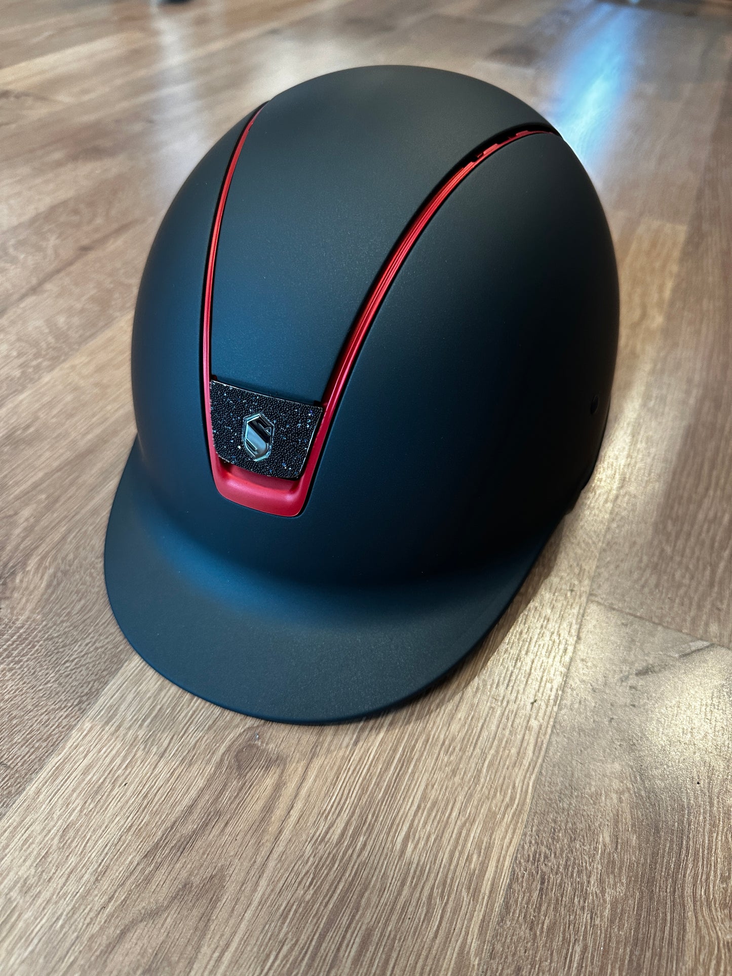 Helmet with red trim and crystal fabric blazon